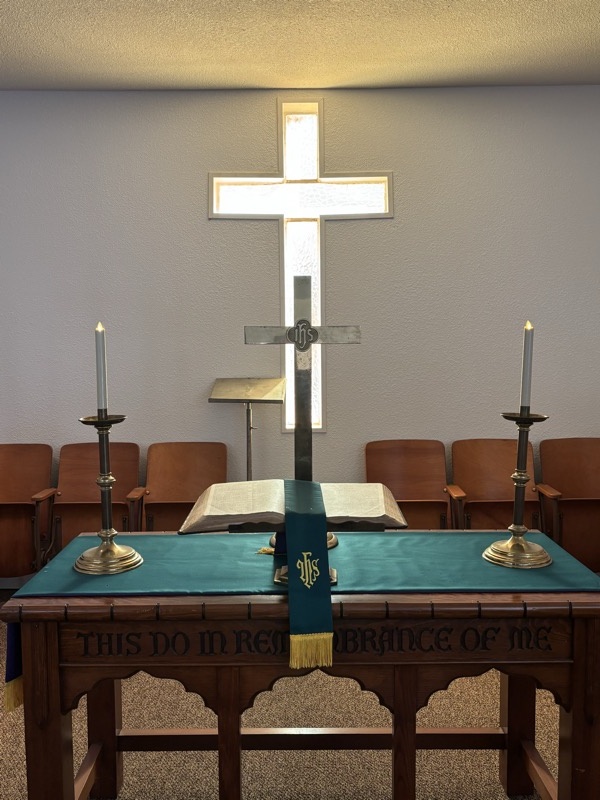 The altar and illuminated cross inside Bellevue Methodist Church